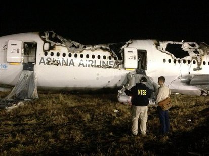 National Transportation Safety Board (NTSB) investigators conduct first site assessment of the wreckage of Asiana Airlines Flight 214, at Sa National Transportation Safety Board (NTSB) investigators conduct first site assessment of the wreckage of Asiana Airlines Flight 214, at Sa