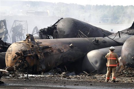 A firefighter works on the scene of a train derailment in Lac Megantic, Quebec, July 7, 2013. REUTERS/Christinne Muschi A firefighter works on the scene of a train derailment in Lac Megantic, Quebec, July 7, 2013. REUTERS/Christinne Muschi