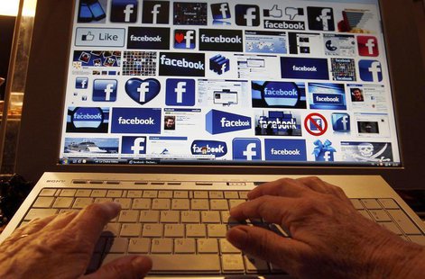 A women works with her computer which displays Facebook logos on the screen in Bordeaux, Southwestern France, January 30, 2013. REUTERS/Regi A women works with her computer which displays Facebook logos on the screen in Bordeaux, Southwestern France, January 30, 2013. REUTERS/Regi