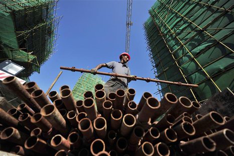 A labourer moves a steel pipe at a residential construction site in Fuzhou, Fujian province July 4, 2013. Picture taken July 4, 2013. REUTER A labourer moves a steel pipe at a residential construction site in Fuzhou, Fujian province July 4, 2013. Picture taken July 4, 2013. REUTER