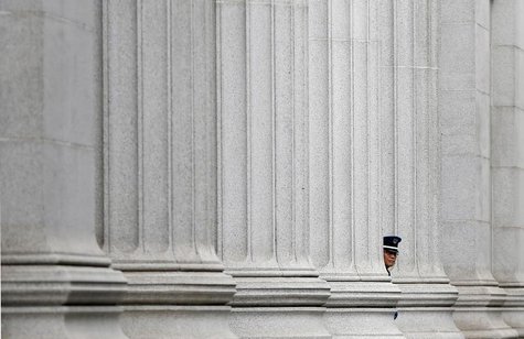 A security guard stands at a bank in front of the Bank of Japan headquarters in Tokyo July 5, 2013. REUTERS/Toru Hanai A security guard stands at a bank in front of the Bank of Japan headquarters in Tokyo July 5, 2013. REUTERS/Toru Hanai