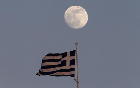 A Greek flag flutters on the top of the parliament as the moon rises in Athens May 23, 2013.. REUTERS/John Kolesidis A Greek flag flutters on the top of the parliament as the moon rises in Athens May 23, 2013.. REUTERS/John Kolesidis