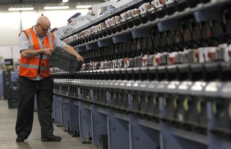 A Royal Mail employee looks through a box of letters at an Edinburgh mail centre in Edinburgh, Scotland December 18, 2012. REUTERS/David Moi A Royal Mail employee looks through a box of letters at an Edinburgh mail centre in Edinburgh, Scotland December 18, 2012. REUTERS/David Moi