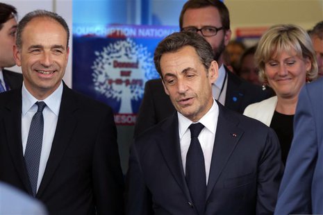 Former French President Nicolas Sarkozy (C), French UMP political party head Jean-Francois Cope (L) and party member Nadine Morano (R) leave Former French President Nicolas Sarkozy (C), French UMP political party head Jean-Francois Cope (L) and party member Nadine Morano (R) leave