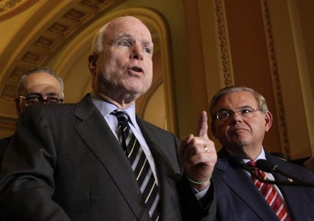U.S. Senator John McCain (R-AZ) speaks to the media next to Senate Foreign Relations Committee Chairman Robert Menendez (D-NJ) after the Sen U.S. Senator John McCain (R-AZ) speaks to the media next to Senate Foreign Relations Committee Chairman Robert Menendez (D-NJ) after the Sen