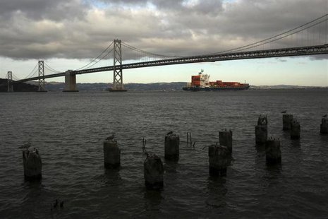 A container ship sails beneath the San Francisco-Oakland Bay Bridge in San Francisco, California March 5, 2013. REUTERS/Robert Galbraith A container ship sails beneath the San Francisco-Oakland Bay Bridge in San Francisco, California March 5, 2013. REUTERS/Robert Galbraith