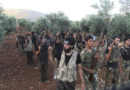 Free Syrian Army fighters, holding their weapons, stand during military training north of Idlib July 7, 2013. Picture taken July 7, 2013. RE Free Syrian Army fighters, holding their weapons, stand during military training north of Idlib July 7, 2013. Picture taken July 7, 2013. RE