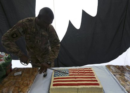 A U.S. soldier cuts into a cake during Fourth of July celebrations at the Bagram airbase, north of Kabul July 4, 2013. REUTERS/Omar Sobhani A U.S. soldier cuts into a cake during Fourth of July celebrations at the Bagram airbase, north of Kabul July 4, 2013. REUTERS/Omar Sobhani