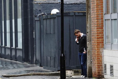 A man speaks on his mobile phone in a street near the Old Street roundabout dubbed "Silicon Roundabout" in London May 28, 2013. REUTERS/Luke A man speaks on his mobile phone in a street near the Old Street roundabout dubbed "Silicon Roundabout" in London May 28, 2013. REUTERS/Luke