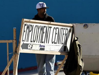 A day labourer stands behind a sign for an employment center in San Diego, January 6, 2011. REUTERS/Mike Blake A day labourer stands behind a sign for an employment center in San Diego, January 6, 2011. REUTERS/Mike Blake