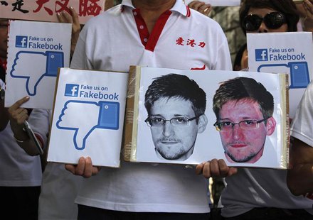 A demonstrator from the pro-China "Caring Hong Kong Power" group protests over claims from former U.S. spy agency contractor Edward Snowden A demonstrator from the pro-China "Caring Hong Kong Power" group protests over claims from former U.S. spy agency contractor Edward Snowden