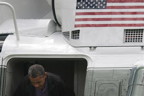 U.S. President Barack Obama ducks his head departing the Marine One helicopter as he returns from a weekend visit at Camp David to the White U.S. President Barack Obama ducks his head departing the Marine One helicopter as he returns from a weekend visit at Camp David to the White