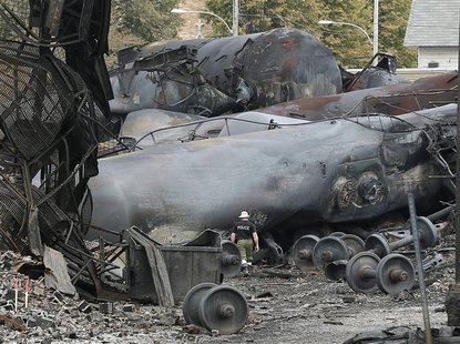 A police officer walks amongst axle gear in Lac Megantic, July 9, 2013. REUTERS/Mathieu Belanger A police officer walks amongst axle gear in Lac Megantic, July 9, 2013. REUTERS/Mathieu Belanger