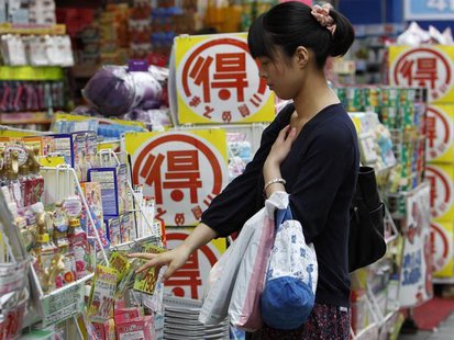 A woman looks at goods outside a drugstore in Tokyo June 28, 2013. REUTERS/Yuya Shino A woman looks at goods outside a drugstore in Tokyo June 28, 2013. REUTERS/Yuya Shino