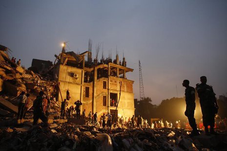 Rescue workers look for trapped garment workers in the collapsed Rana Plaza building in Savar, 30 km (19 miles) outside Dhaka April 26, 2013 Rescue workers look for trapped garment workers in the collapsed Rana Plaza building in Savar, 30 km (19 miles) outside Dhaka April 26, 2013