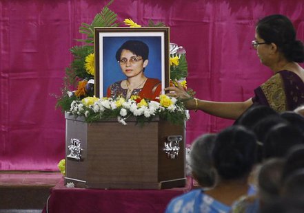 A woman puts flowers on Jacintha Saldanha's coffin during her funeral inside a church in Shirva, about 52 km (32 miles) north of Mangalore D A woman puts flowers on Jacintha Saldanha's coffin during her funeral inside a church in Shirva, about 52 km (32 miles) north of Mangalore D