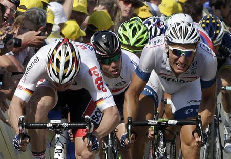 (L-R) Lotto-Belisol team rider Andre Greipel of Germany, Omega Pharma-Quick Step team rider Mark Cavendish of Britain and Argos-Shimano team (L-R) Lotto-Belisol team rider Andre Greipel of Germany, Omega Pharma-Quick Step team rider Mark Cavendish of Britain and Argos-Shimano team