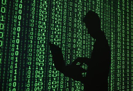 An illustration picture shows a projection of binary code around the shadow of a man holding a laptop computer in an office in Warsaw June 2 An illustration picture shows a projection of binary code around the shadow of a man holding a laptop computer in an office in Warsaw June 2