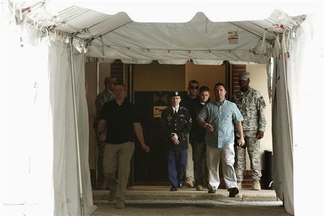 U.S. Army Private First Class Bradley Manning (C, in dress uniform) is escorted out after a day of testimony at his court martial trial at F U.S. Army Private First Class Bradley Manning (C, in dress uniform) is escorted out after a day of testimony at his court martial trial at F