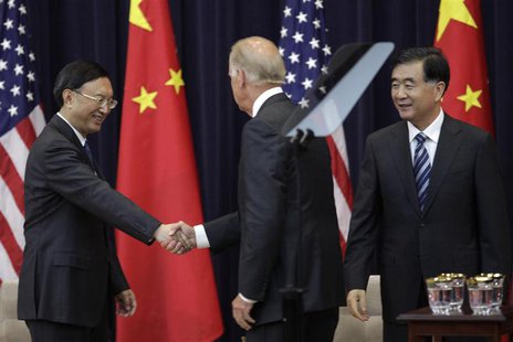 U.S. Vice President Joe Biden (C) shakes hands with Chinese State Councilor Yang Jiechi as Chinese Vice Premier Wang Yang (R) look on during U.S. Vice President Joe Biden (C) shakes hands with Chinese State Councilor Yang Jiechi as Chinese Vice Premier Wang Yang (R) look on during