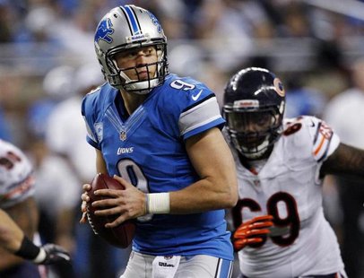 Detroit Lions quarterback Matthew Stafford looks for his receiver while being pressured by the Chicago Bears defense during the second half Detroit Lions quarterback Matthew Stafford looks for his receiver while being pressured by the Chicago Bears defense during the second half