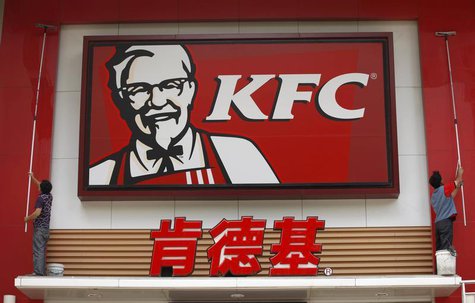 Labourers clean the external wall of a KFC restaurant in Huaibei, Anhui province June 13, 2013. REUTERS/Stringer Labourers clean the external wall of a KFC restaurant in Huaibei, Anhui province June 13, 2013. REUTERS/Stringer