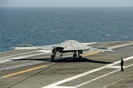 An X-47B pilot-less drone combat aircraft comes to a stop after landing on the deck of the USS George H.W. Bush aircraft carrier in the Atla An X-47B pilot-less drone combat aircraft comes to a stop after landing on the deck of the USS George H.W. Bush aircraft carrier in the Atla