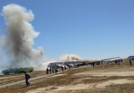 Passengers evacuate from Asiana Airlines Boeing 777 aircraft after a crash landing at San Francisco International Airport in San Francisco, Passengers evacuate from Asiana Airlines Boeing 777 aircraft after a crash landing at San Francisco International Airport in San Francisco,