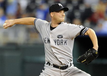 New York Yankees relief pitcher Chad Gaudin delivers a sixth inning pitch against the Kansas City Royals during their rain-delayed MLB Ameri New York Yankees relief pitcher Chad Gaudin delivers a sixth inning pitch against the Kansas City Royals during their rain-delayed MLB Ameri