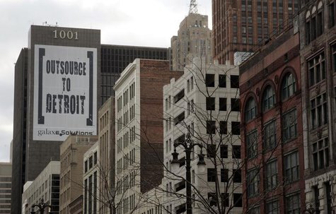 A larger banner reading "Outsource to Detroit" is seen on the side of a building on Woodward Ave in downtown Detroit, Michigan, January 7, 2 A larger banner reading "Outsource to Detroit" is seen on the side of a building on Woodward Ave in downtown Detroit, Michigan, January 7, 2