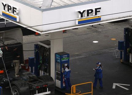 Employees work at a YPF gas station in Buenos Aires May 23, 2013. REUTERS/Marcos Brindicci Employees work at a YPF gas station in Buenos Aires May 23, 2013. REUTERS/Marcos Brindicci