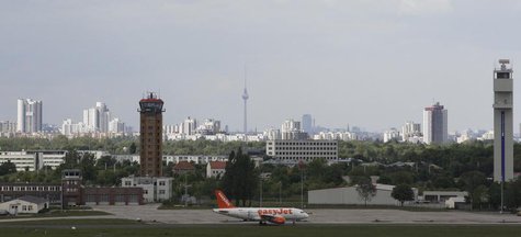 An aircraft operated by easyJet sits on tarmac with the skyline of German capital of Berlin in the background at Schoenefeld airport, May 17 An aircraft operated by easyJet sits on tarmac with the skyline of German capital of Berlin in the background at Schoenefeld airport, May 17