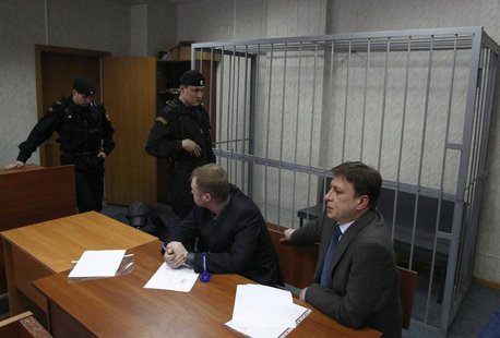 Attorneys of lawyer Sergei Magnitsky sit in front of an empty defendants' cage during a court session in Moscow March 22, 2013. REUTERS/Mikh Attorneys of lawyer Sergei Magnitsky sit in front of an empty defendants' cage during a court session in Moscow March 22, 2013. REUTERS/Mikh