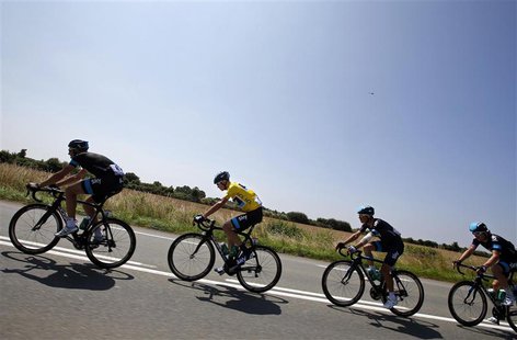 Race leader yellow jersey holder Team Sky rider Christopher Froome of Britain cycles with team mates during the twelfth 218km stage of the c Race leader yellow jersey holder Team Sky rider Christopher Froome of Britain cycles with team mates during the twelfth 218km stage of the c