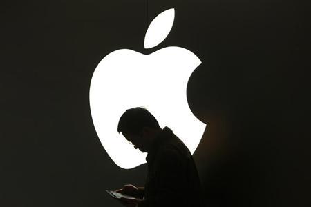 A man looks at his Apple iPad in front an Apple logo outside an Apple store in downtown Shanghai March 16, 2012.
(Credit: Reuters/Aly Song) A man looks at his Apple iPad in front an Apple logo outside an Apple store in downtown Shanghai March 16, 2012.
(Credit: Reuters/Aly Song)