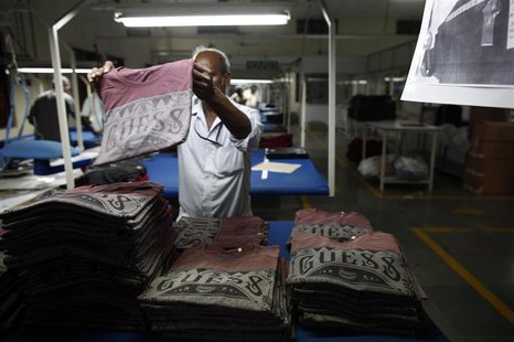 An employee sorts newly finished T-shirts at the Estee garment factory in Tirupur in the southern Indian state of Tamil Nadu June 19, 2013. An employee sorts newly finished T-shirts at the Estee garment factory in Tirupur in the southern Indian state of Tamil Nadu June 19, 2013.