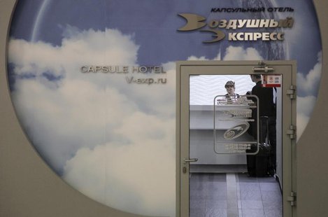A man stands at the reception of the Capsule Hotel "Air Express" in Moscow's Sheremetyevo airport June 27, 2013. REUTERS/Stringer A man stands at the reception of the Capsule Hotel "Air Express" in Moscow's Sheremetyevo airport June 27, 2013. REUTERS/Stringer