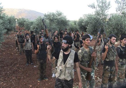 Free Syrian Army fighters, holding their weapons, stand during military training north of Idlib July 7, 2013. REUTERS/Abdalghne Karoof Free Syrian Army fighters, holding their weapons, stand during military training north of Idlib July 7, 2013. REUTERS/Abdalghne Karoof