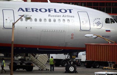 Airport staff walk under Aeroflot's Moscow-Havana flight aircraft at Havana's Jose Marti International Airport July 11, 2013. REUTERS/Desmon Airport staff walk under Aeroflot's Moscow-Havana flight aircraft at Havana's Jose Marti International Airport July 11, 2013. REUTERS/Desmon