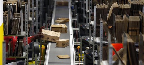 A worker packs boxes at Amazon's logistics centre in Graben near Augsburg December 17, 2012. REUTERS/Michael Dalder A worker packs boxes at Amazon's logistics centre in Graben near Augsburg December 17, 2012. REUTERS/Michael Dalder
