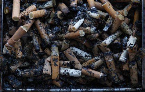 Used cigarette butts spill out of a full ashtray on the wall of a shopping centre in Warrington, northern England January 15, 2013. REUTERS/ Used cigarette butts spill out of a full ashtray on the wall of a shopping centre in Warrington, northern England January 15, 2013. REUTERS/