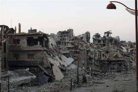 A general view shows damaged buildings on a deserted street in the besieged area of Homs July 12, 2013. REUTERS/Yazan Homsy A general view shows damaged buildings on a deserted street in the besieged area of Homs July 12, 2013. REUTERS/Yazan Homsy