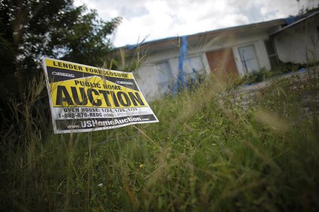 An auction sign for a property is seen at the front garden of a foreclosed house in Miami Gardens, Florida September 15, 2009. REUTERS/Carlo An auction sign for a property is seen at the front garden of a foreclosed house in Miami Gardens, Florida September 15, 2009. REUTERS/Carlo