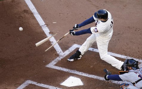 Minnesota Twins' Justin Morneau breaks his bat as he flies out to Detroit Tigers right fielder Torii Hunter to end the first inning of their Minnesota Twins' Justin Morneau breaks his bat as he flies out to Detroit Tigers right fielder Torii Hunter to end the first inning of their