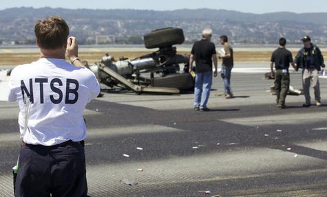 U.S. National Transportation Safety Board (NTSB) investigators attend to the scene of the Asiana Airlines Flight 214 crash site at San Franc U.S. National Transportation Safety Board (NTSB) investigators attend to the scene of the Asiana Airlines Flight 214 crash site at San Franc
