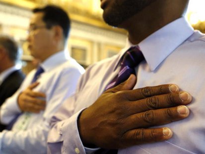 Herbert Crooks (Panama) (R) says the Pledge of Allegiance after he swears in as United States citizen during a Special Naturalization Ceremo Herbert Crooks (Panama) (R) says the Pledge of Allegiance after he swears in as United States citizen during a Special Naturalization Ceremo
