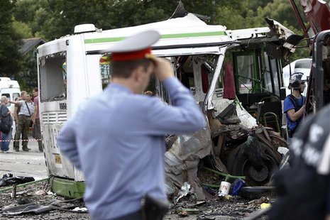 Members of the emergency services and police work at the scene of a collision between a bus and a truck outside Moscow July 13, 2013. REUTER Members of the emergency services and police work at the scene of a collision between a bus and a truck outside Moscow July 13, 2013. REUTER
