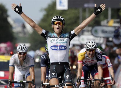 Omega Pharma-Quick Step team Matteo Trentin of Italy celebrates as he crosses the finish line to win the 191 km fourteenth stage of the cent Omega Pharma-Quick Step team Matteo Trentin of Italy celebrates as he crosses the finish line to win the 191 km fourteenth stage of the cent
