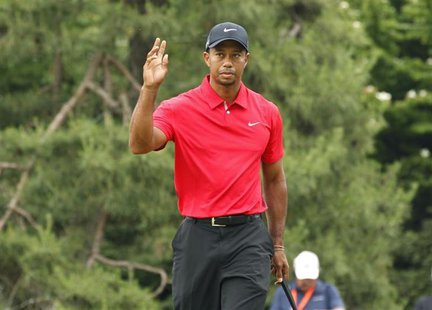 Tiger Woods of the U.S. reacts after putting on the first green during the final round of the 2013 U.S. Open golf championship at the Merion Tiger Woods of the U.S. reacts after putting on the first green during the final round of the 2013 U.S. Open golf championship at the Merion
