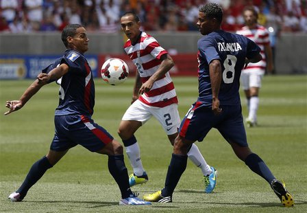 Cuba's Joel Colome (L) and Jaine Valencia defend against Edgar Castillo (C) of the U.S. during their CONCACAF Gold Cup soccer match in Salt Cuba's Joel Colome (L) and Jaine Valencia defend against Edgar Castillo (C) of the U.S. during their CONCACAF Gold Cup soccer match in Salt